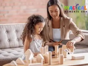 Therapist guiding a child playing with wooden blocks during ABA therapy